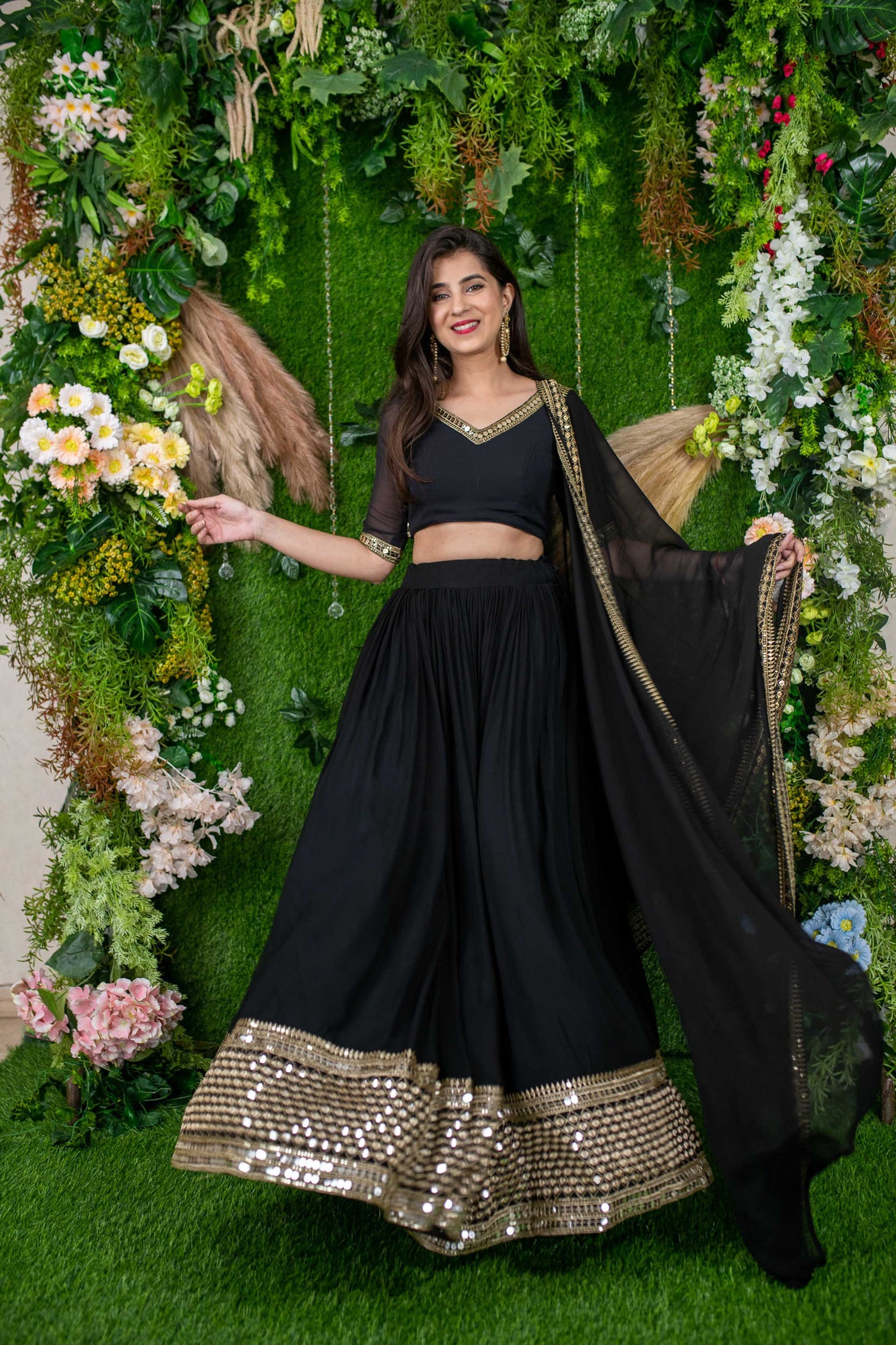BLACK LEHENGA SET WITH MULTI COLOURED PATTERNED THREAD WORK AND A MIRROR  EMBROIDERED BLOUSE AND CUMMERBUND PAIRED WITH A MATCHING DUPATTA AND ALL  OVER GOLD EMBELLISHMENTS. - Seasons India